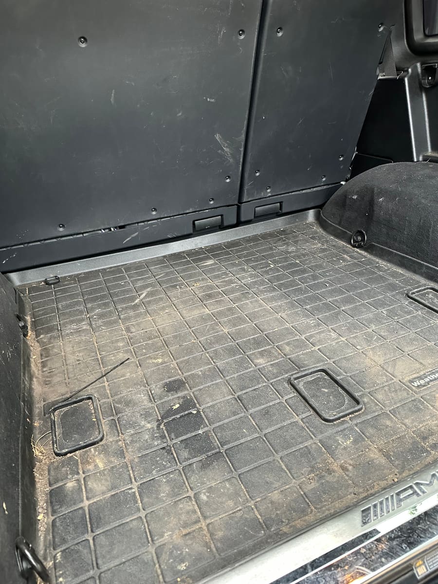 Wide view of cargo area before detailing, dusty with debris